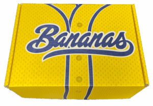 A custom yellow corrugated mailer box designed for Savannah Bananas, featuring interior banana graphics and bold “Delivered Fresh” messaging